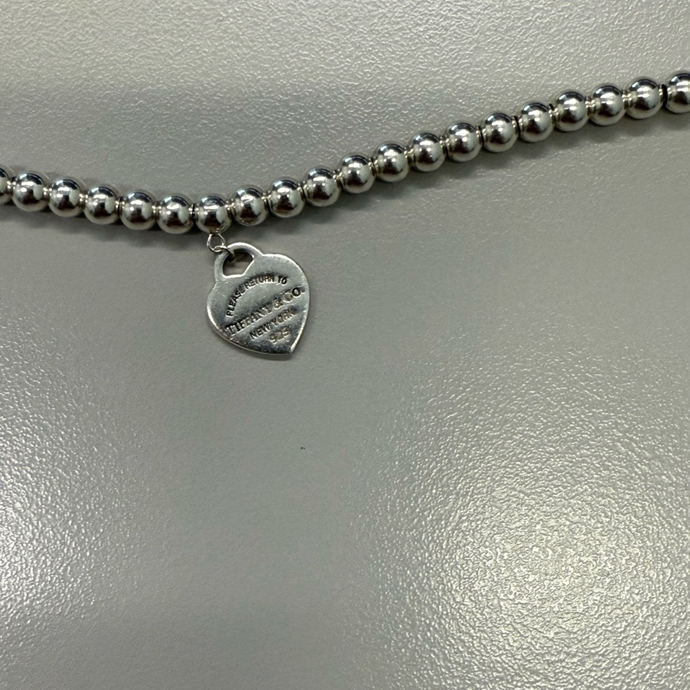 Tiffany co Silver Beaded bracelet with Heart Pendant
About 6.5 inches